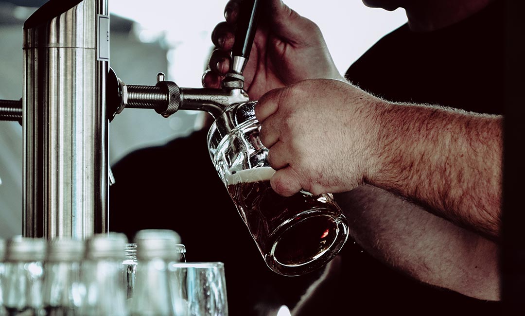 Bartender pouring a beer at the festival